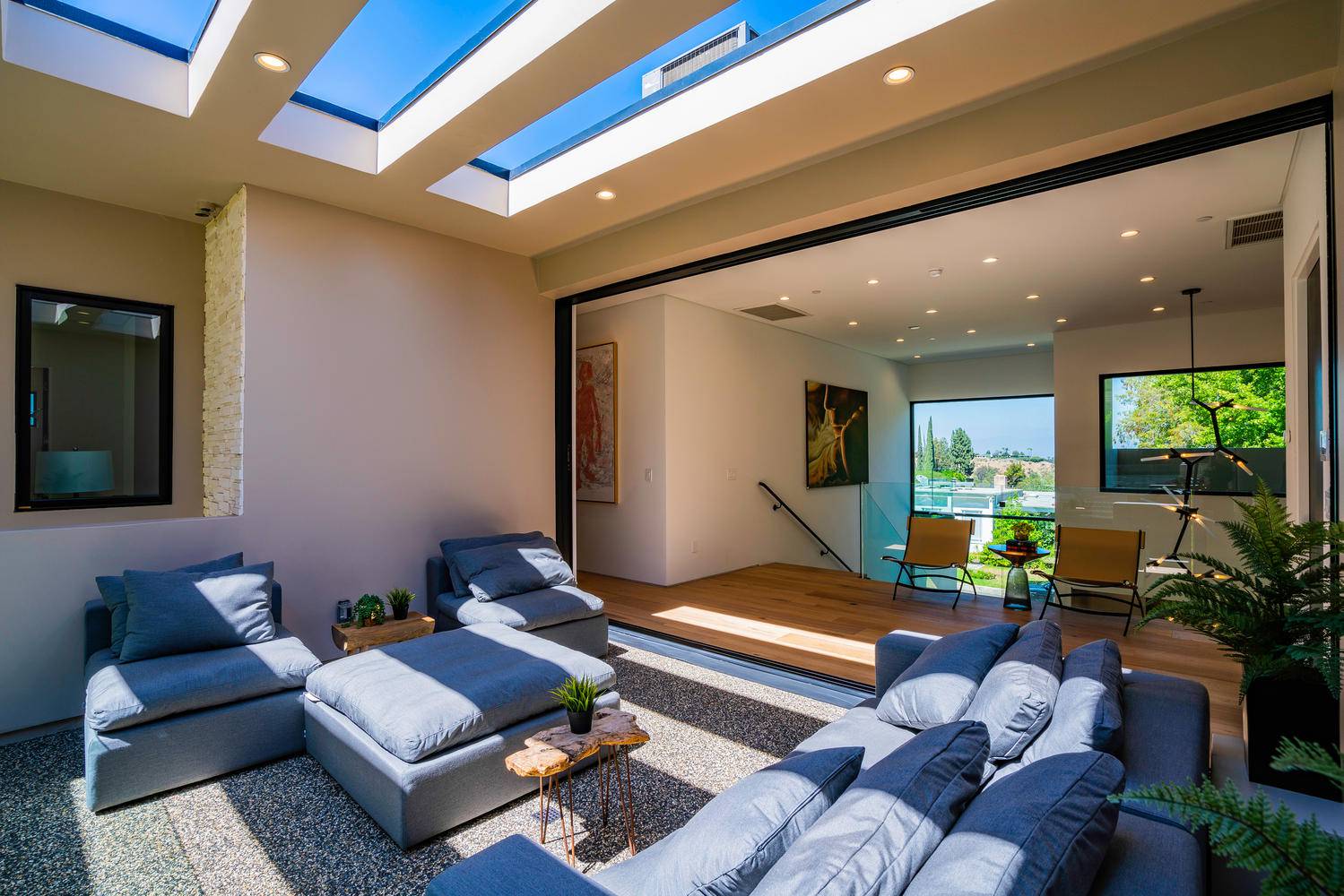 The great room totally opens with outdoor spaces and directs to amazing pool in the center