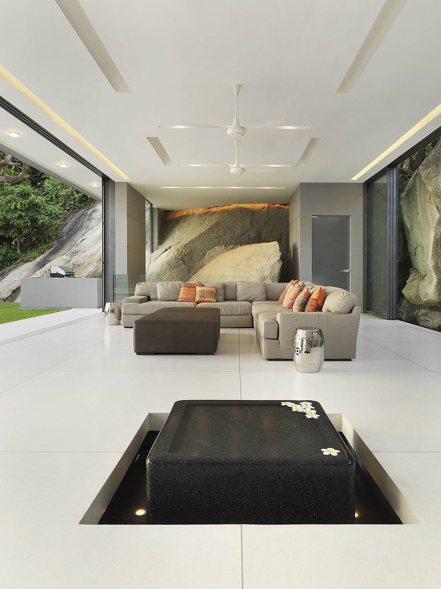 The great room totally opens with outdoor spaces and directs to amazing pool in the center