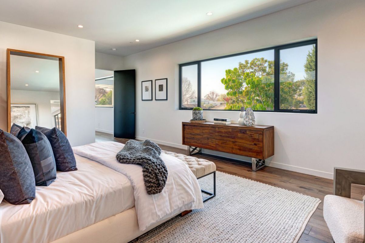 The great room totally opens with outdoor spaces and directs to amazing pool in the center