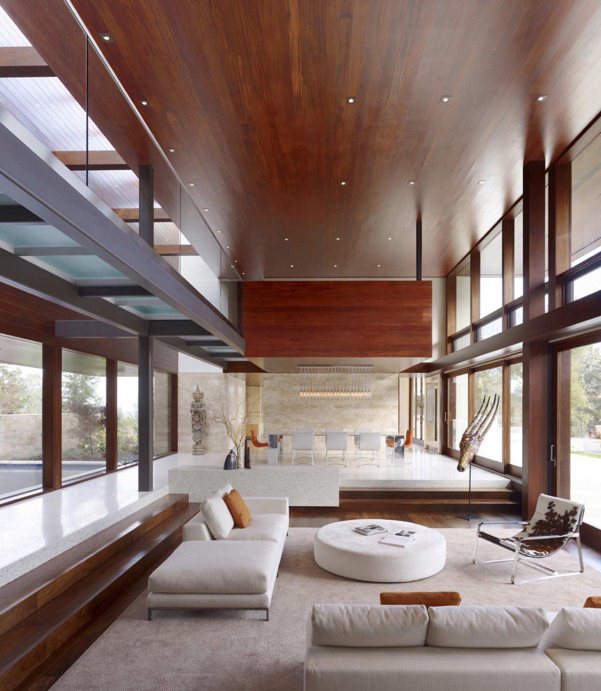 The great room totally opens with outdoor spaces and directs to amazing pool in the center