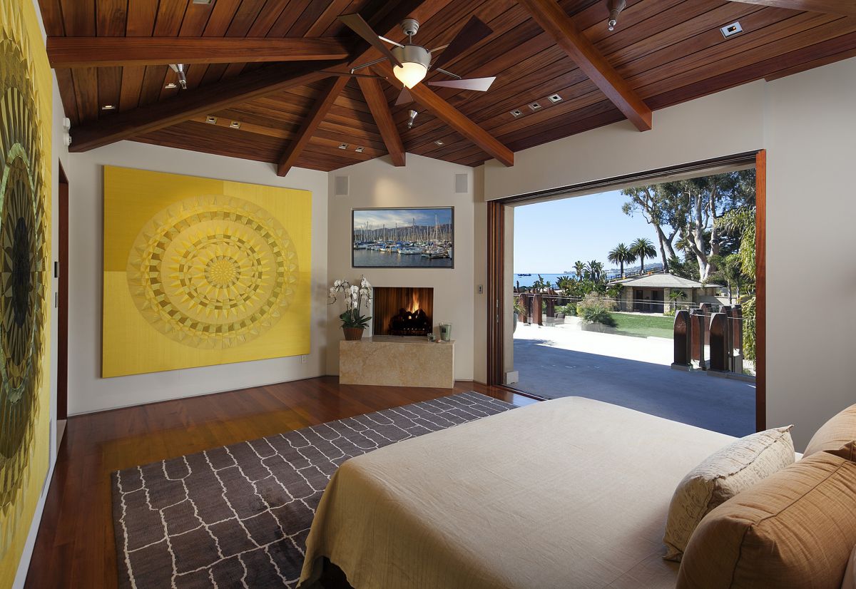 If other design elements are present in your rustic space, that is more than acceptable. I enjoy combining various patterns, hues, and accessories. That much is obvious—from the almost glam quartz wall print to the conventional wood-framed upholstered headboard, this room's unique fusion of textures, patterns, and finishes is what makes it so special.