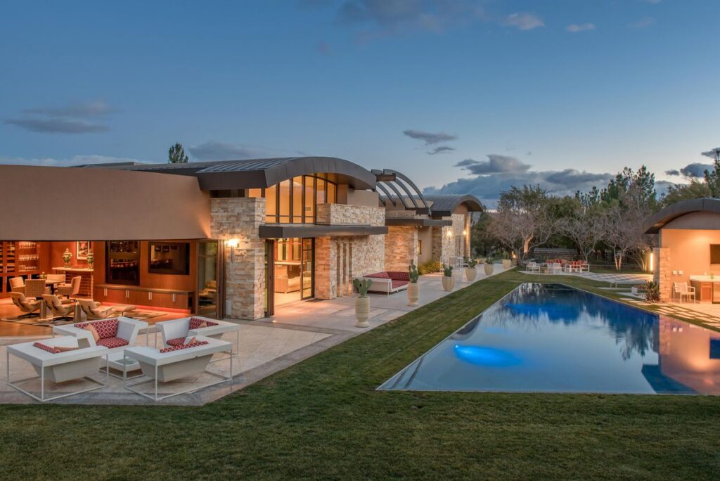 The Las Vegas Home for Sale is a luxuriously expansive and private estate in Summerlin now available for sale. This home located at 99 Hawk Ridge Dr, Las Vegas, Nevada; offering 8 bedrooms and 10 bathrooms with over 13,400 square feet of living spaces