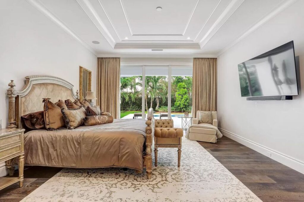 The Home for Sale in Boca Raton is a luxurious home with with specimen palms, is prelude to an up-lit mature tropical landscape, hedged and gated for privacy. This home located at 1717 Sabal Palm Dr, Boca Raton, Florida; offering 5 bedrooms and 9 bathrooms with over 6,800 square feet of living spaces.