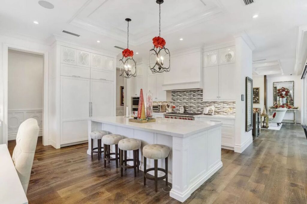 The Home for Sale in Boca Raton is a luxurious home with with specimen palms, is prelude to an up-lit mature tropical landscape, hedged and gated for privacy. This home located at 1717 Sabal Palm Dr, Boca Raton, Florida; offering 5 bedrooms and 9 bathrooms with over 6,800 square feet of living spaces.