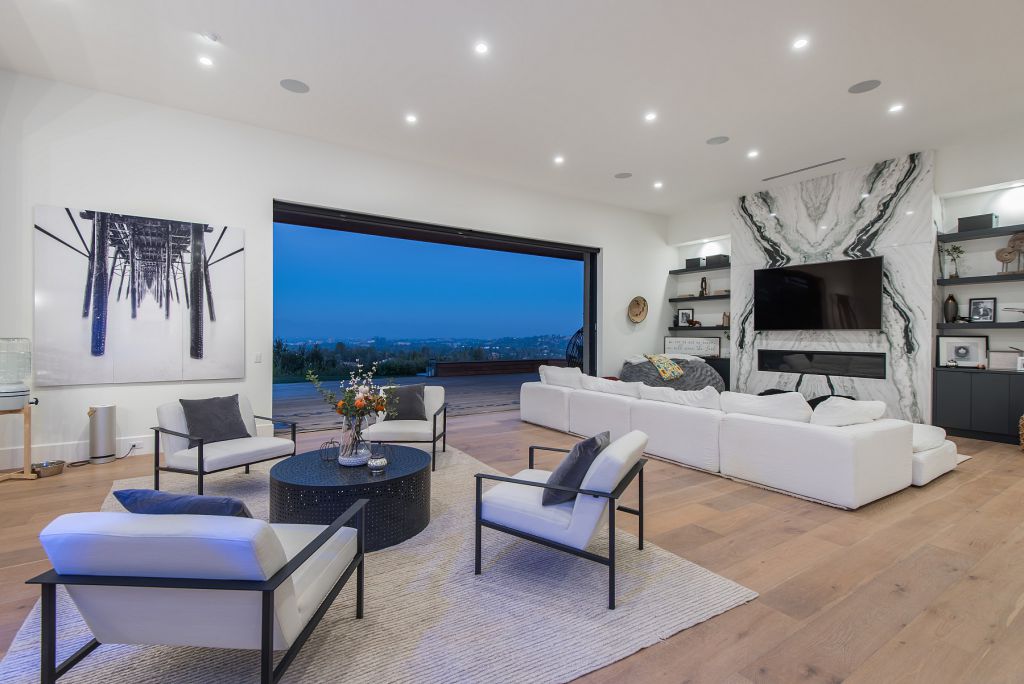 The Hidden Hills House is an absolutely extraordinary single story modern with explosive panoramic unobstructed city light views now available for sale. This home located at 5550 Bonneville Rd, Hidden Hills, California; offering 4 bedrooms and 5 bathrooms with over 4,800 square feet of living spaces.