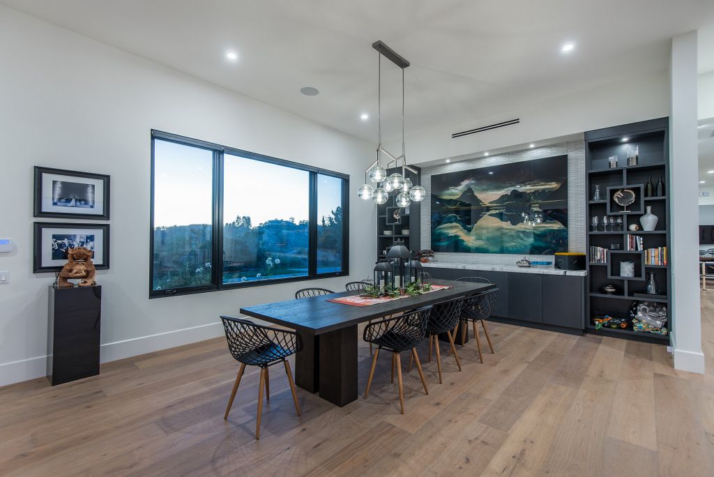 The Hidden Hills House is an absolutely extraordinary single story modern with explosive panoramic unobstructed city light views now available for sale. This home located at 5550 Bonneville Rd, Hidden Hills, California; offering 4 bedrooms and 5 bathrooms with over 4,800 square feet of living spaces.
