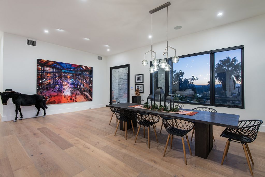 The Hidden Hills House is an absolutely extraordinary single story modern with explosive panoramic unobstructed city light views now available for sale. This home located at 5550 Bonneville Rd, Hidden Hills, California; offering 4 bedrooms and 5 bathrooms with over 4,800 square feet of living spaces.