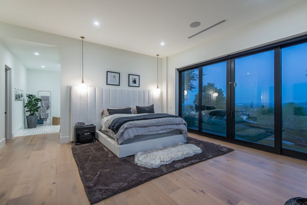 The Hidden Hills House is an absolutely extraordinary single story modern with explosive panoramic unobstructed city light views now available for sale. This home located at 5550 Bonneville Rd, Hidden Hills, California; offering 4 bedrooms and 5 bathrooms with over 4,800 square feet of living spaces.