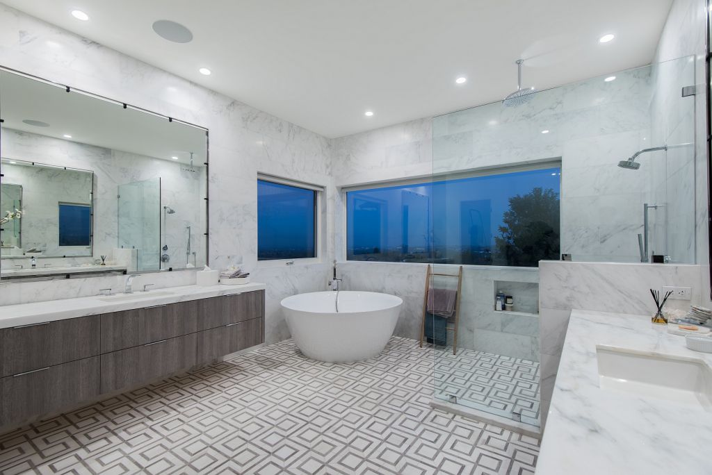 The Hidden Hills House is an absolutely extraordinary single story modern with explosive panoramic unobstructed city light views now available for sale. This home located at 5550 Bonneville Rd, Hidden Hills, California; offering 4 bedrooms and 5 bathrooms with over 4,800 square feet of living spaces.