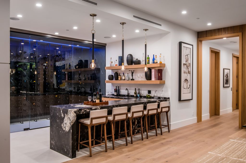 The House in Encino is a newly constructed contemporary masterpiece with unobstructed views in the coveted Royal Oaks now available for sale. This home located at 3950 Royal Oak Pl, Encino, California; offering 8 bedrooms and 14 bathrooms with over 13,000 square feet of living spaces