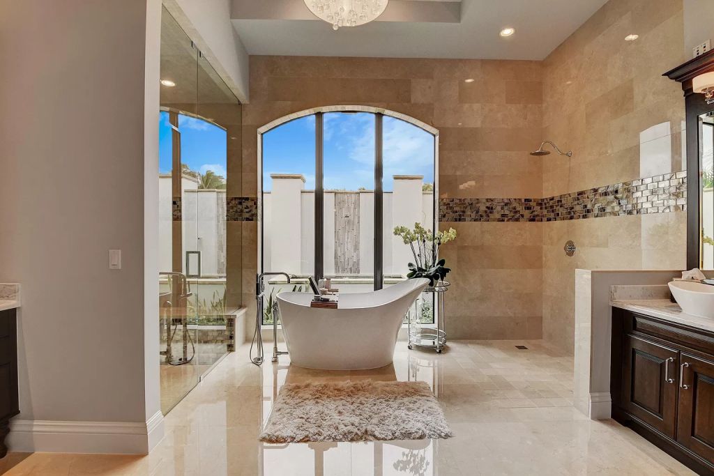 The Boca Raton House is an incredible Intracoastal estate features Resort style living with pool, outdoor kitchen and bar now available for sale. This home located at 7596 NE Orchid Bay Ter, Boca Raton, Florida; offering 5 bedrooms and 7 bathrooms with over 8,000 square feet of living spaces.
