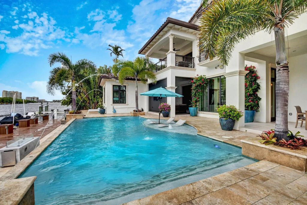 The Boca Raton House is an incredible Intracoastal estate features Resort style living with pool, outdoor kitchen and bar now available for sale. This home located at 7596 NE Orchid Bay Ter, Boca Raton, Florida; offering 5 bedrooms and 7 bathrooms with over 8,000 square feet of living spaces.