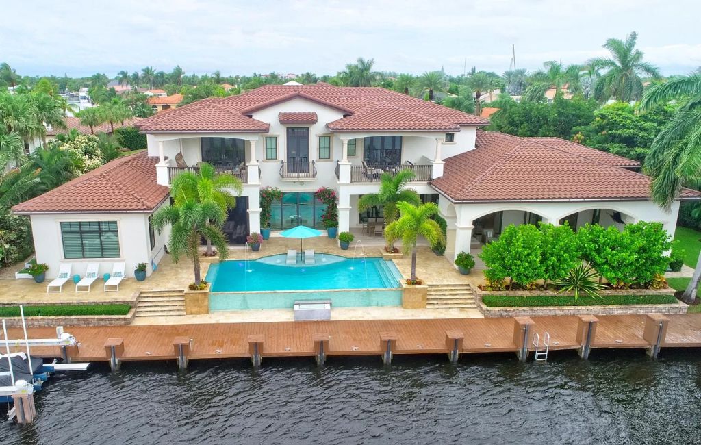 The Boca Raton House is an incredible Intracoastal estate features Resort style living with pool, outdoor kitchen and bar now available for sale. This home located at 7596 NE Orchid Bay Ter, Boca Raton, Florida; offering 5 bedrooms and 7 bathrooms with over 8,000 square feet of living spaces.