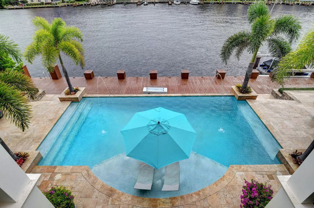 The Boca Raton House is an incredible Intracoastal estate features Resort style living with pool, outdoor kitchen and bar now available for sale. This home located at 7596 NE Orchid Bay Ter, Boca Raton, Florida; offering 5 bedrooms and 7 bathrooms with over 8,000 square feet of living spaces.
