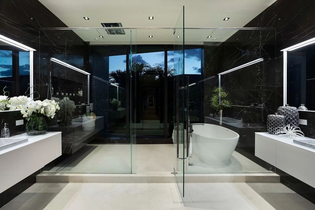 The Boca Raton House is an architectural deepwater estate in The Sanctuary with 3-levels of luxury and style now available for sale. This home located at 824 Pelican Point Cv, Boca Raton, Florida; offering 7 bedrooms and 10 bathrooms with over 7,300 square feet of living spaces.