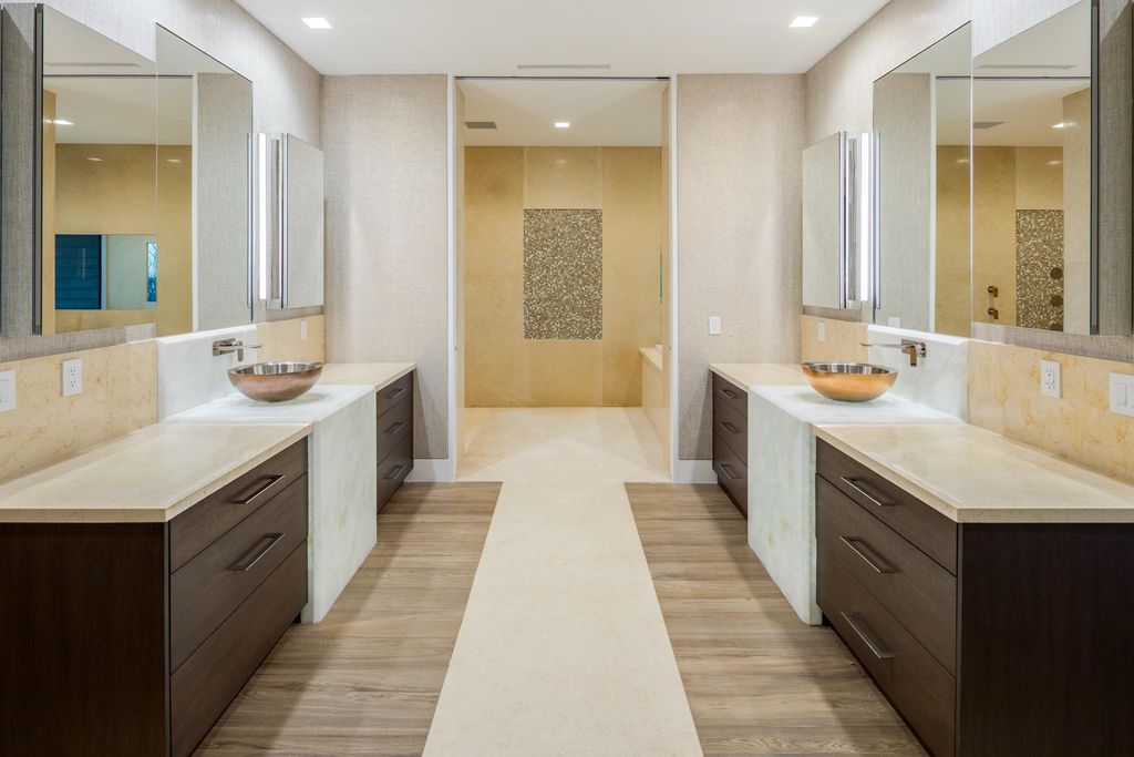 The Modern Mansion in Jupiter Island features spacious living and entertaining spaces with the most panoramic views of the Ocean now available for sale. This home located at 609 S Beach Rd, Jupiter, Florida; offering 6 bedrooms and 9 bathrooms with over 11,700 square feet of living spaces.