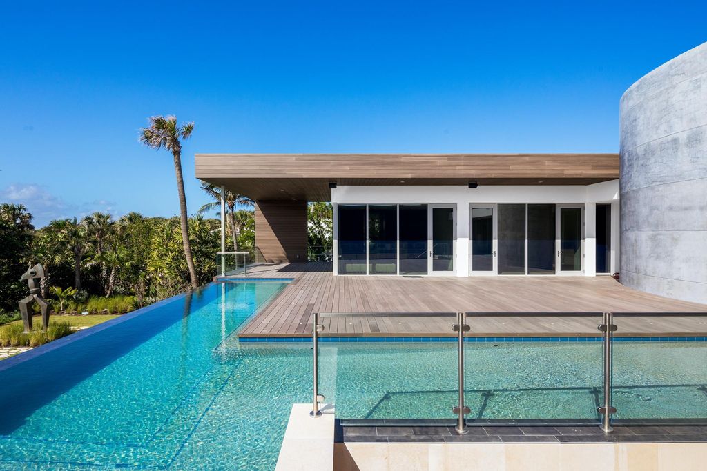 The Modern Mansion in Jupiter Island features spacious living and entertaining spaces with the most panoramic views of the Ocean now available for sale. This home located at 609 S Beach Rd, Jupiter, Florida; offering 6 bedrooms and 9 bathrooms with over 11,700 square feet of living spaces.