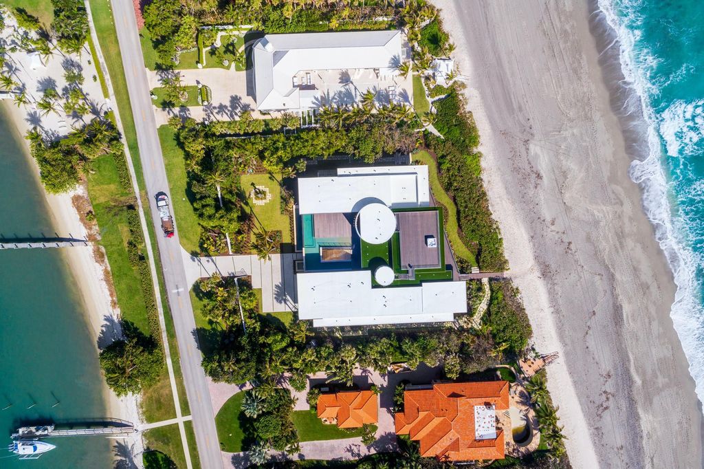 The Modern Mansion in Jupiter Island features spacious living and entertaining spaces with the most panoramic views of the Ocean now available for sale. This home located at 609 S Beach Rd, Jupiter, Florida; offering 6 bedrooms and 9 bathrooms with over 11,700 square feet of living spaces.