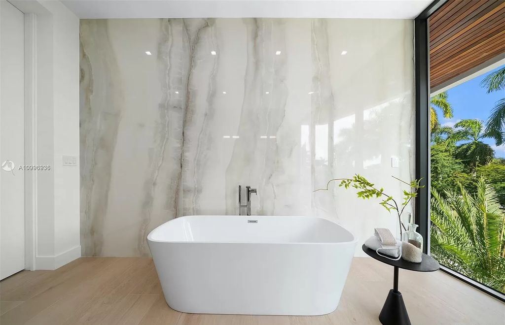 The Home in Miami Beach is a new construction modern oasis located on guard gated Hibiscus Island now available for sale. This home located at 112 W Palm Midway, Miami Beach, Florida; offering 5 bedrooms and 6 bathrooms with over 4,400 square feet of living spaces.