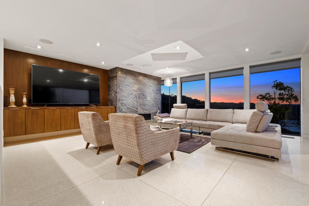 The Los Angeles Home is a Mid-Century Modern retreat boasts jetliner mountain and city views now available for sale. This home located at 8030 Mulholland Dr, Los Angeles, California; offering 3 bedrooms and 6 bathrooms with over 4,500 square feet of living spaces.