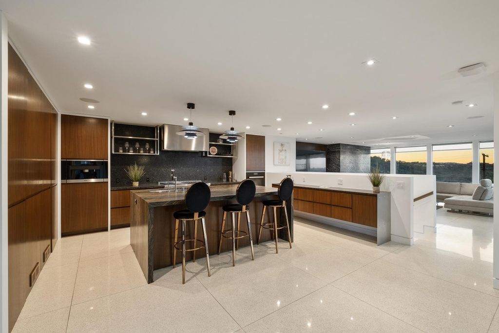 The Los Angeles Home is a Mid-Century Modern retreat boasts jetliner mountain and city views now available for sale. This home located at 8030 Mulholland Dr, Los Angeles, California; offering 3 bedrooms and 6 bathrooms with over 4,500 square feet of living spaces.