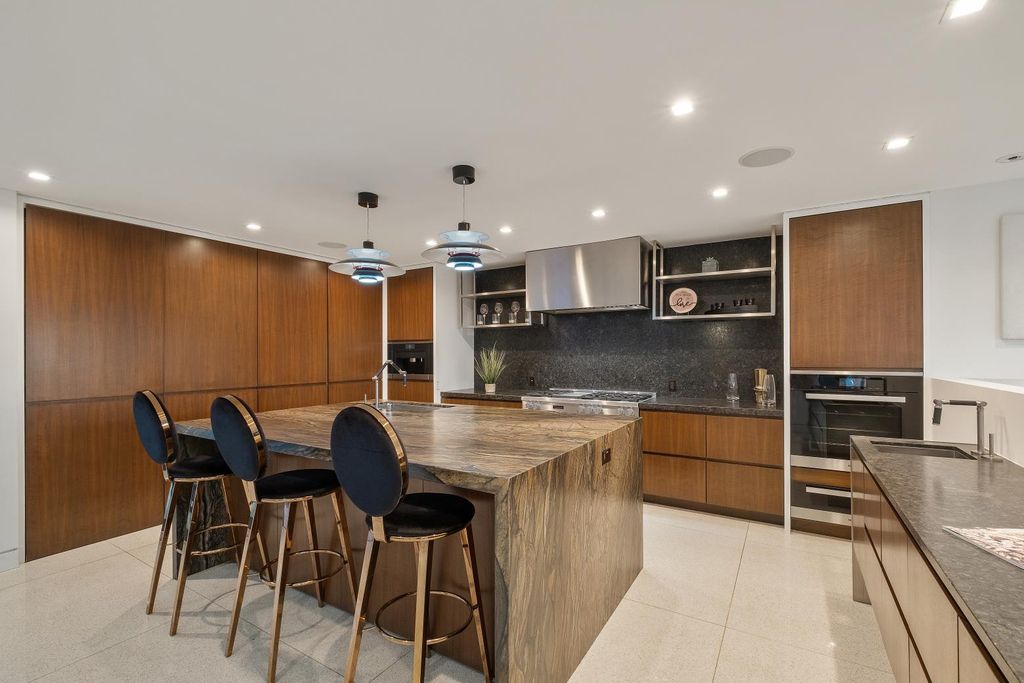 The Los Angeles Home is a Mid-Century Modern retreat boasts jetliner mountain and city views now available for sale. This home located at 8030 Mulholland Dr, Los Angeles, California; offering 3 bedrooms and 6 bathrooms with over 4,500 square feet of living spaces.