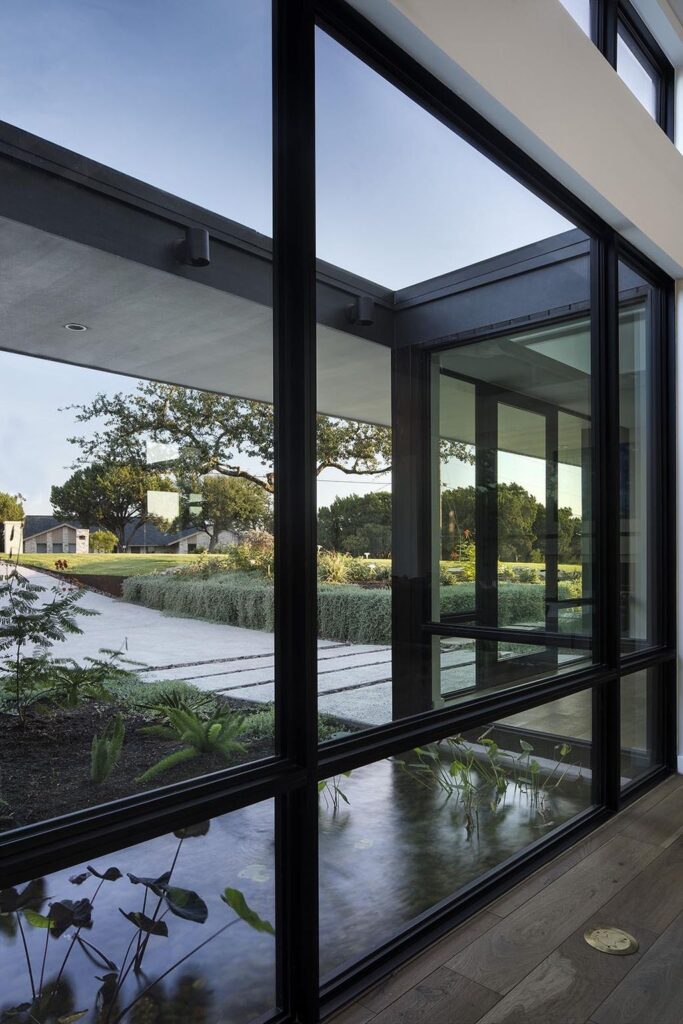 Lakeway House in Austin was designed by Clark Richardson Architects in Modern style with 3 bedrooms and 4 bathrooms on a gently sloping site; The long open floor plan, tall ceilings with ample glazing, and the courtyard parti all work in harmony with passive solar principles and prevailing breezes to allow for an efficient green design
