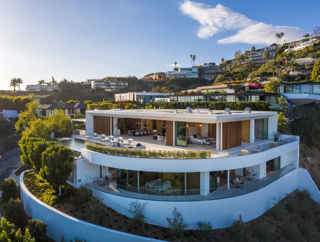 The Hollywood Hills Mansion is an amenity-rich entertainer’s paradise within walking distance to the iconic Sunset Strip now available for sale. This home located at 1422 Devlin Dr, Los Angeles, California; offering 6 bedrooms and 10 bathrooms with over 10,000 square feet of living spaces.
