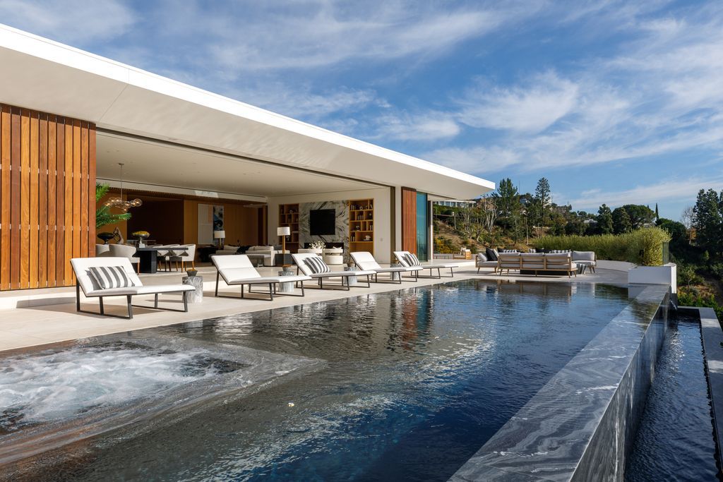 The Hollywood Hills Mansion is an amenity-rich entertainer’s paradise within walking distance to the iconic Sunset Strip now available for sale. This home located at 1422 Devlin Dr, Los Angeles, California; offering 6 bedrooms and 10 bathrooms with over 10,000 square feet of living spaces.