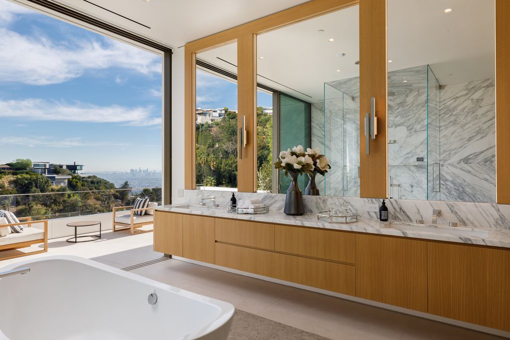 The Hollywood Hills Mansion is an amenity-rich entertainer’s paradise within walking distance to the iconic Sunset Strip now available for sale. This home located at 1422 Devlin Dr, Los Angeles, California; offering 6 bedrooms and 10 bathrooms with over 10,000 square feet of living spaces.