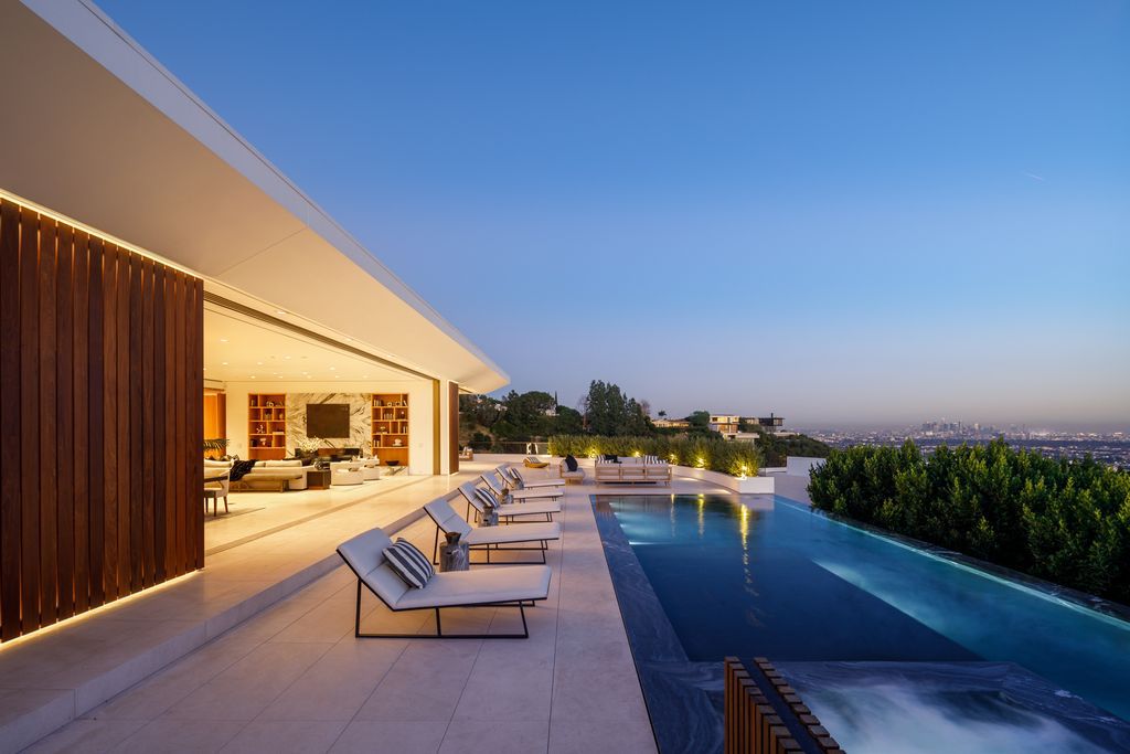 The Hollywood Hills Mansion is an amenity-rich entertainer’s paradise within walking distance to the iconic Sunset Strip now available for sale. This home located at 1422 Devlin Dr, Los Angeles, California; offering 6 bedrooms and 10 bathrooms with over 10,000 square feet of living spaces.