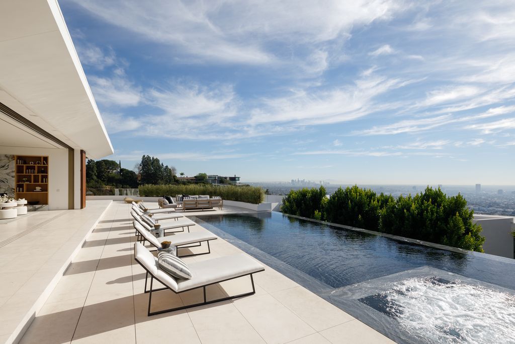 The Hollywood Hills Mansion is an amenity-rich entertainer’s paradise within walking distance to the iconic Sunset Strip now available for sale. This home located at 1422 Devlin Dr, Los Angeles, California; offering 6 bedrooms and 10 bathrooms with over 10,000 square feet of living spaces.