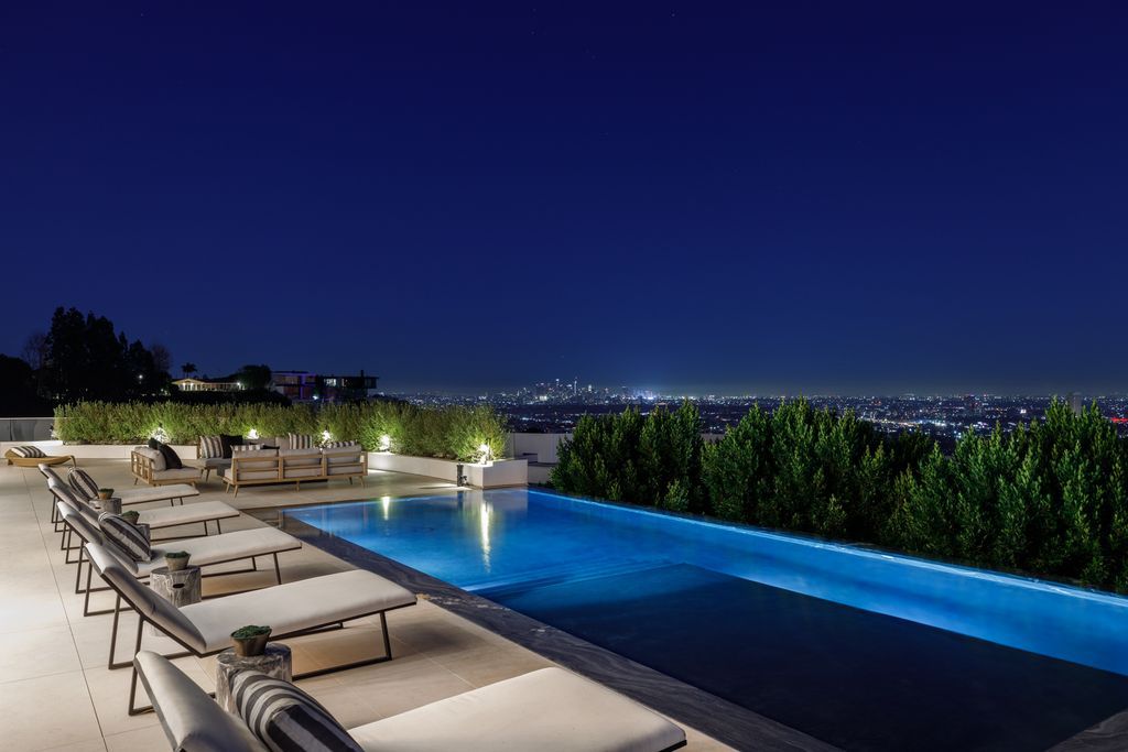 The Hollywood Hills Mansion is an amenity-rich entertainer’s paradise within walking distance to the iconic Sunset Strip now available for sale. This home located at 1422 Devlin Dr, Los Angeles, California; offering 6 bedrooms and 10 bathrooms with over 10,000 square feet of living spaces.