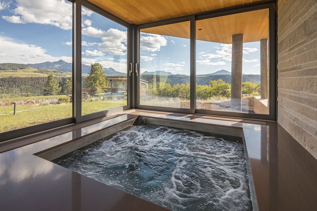 The Colorado Mansion is a modern architectural masterpiece is perched on a point featuring thrilling views of Telluride's most dramatic peaks now available for sale. This home located at 296 Gray Head Ln, Telluride, Colorado; offering 6 bedrooms and 10 bathrooms with over 11,800 square feet of living spaces.
