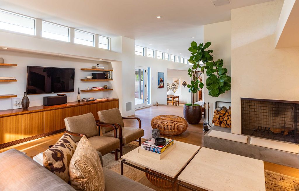 The Mid Century Home in Beverly Hills is a organic property offers total privacy, effortless indoor - outdoor living and unparalleled treetop views now available for sale. This home located at 1030 Woodland Dr, Beverly Hills, California; offering 4 bedrooms and 4 bathrooms with over 4,400 square feet of living spaces.