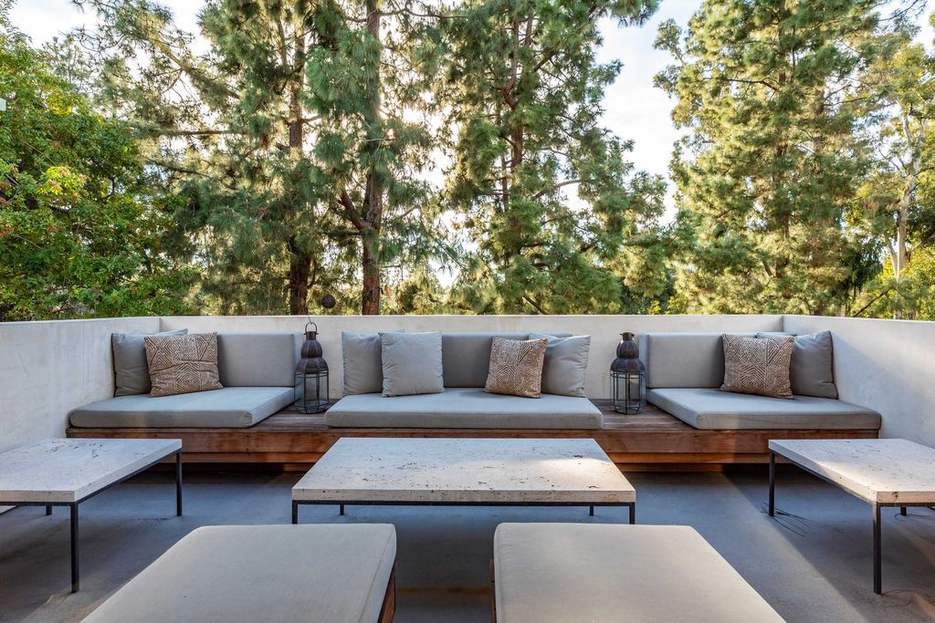 The Mid Century Home in Beverly Hills is a organic property offers total privacy, effortless indoor - outdoor living and unparalleled treetop views now available for sale. This home located at 1030 Woodland Dr, Beverly Hills, California; offering 4 bedrooms and 4 bathrooms with over 4,400 square feet of living spaces.