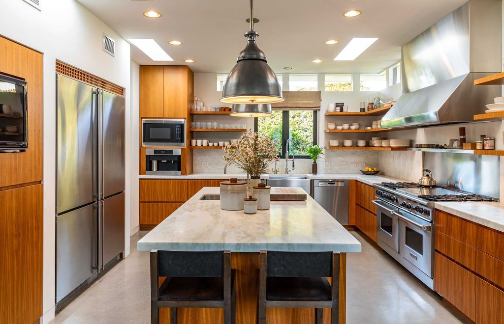 The Mid Century Home in Beverly Hills is a organic property offers total privacy, effortless indoor - outdoor living and unparalleled treetop views now available for sale. This home located at 1030 Woodland Dr, Beverly Hills, California; offering 4 bedrooms and 4 bathrooms with over 4,400 square feet of living spaces.