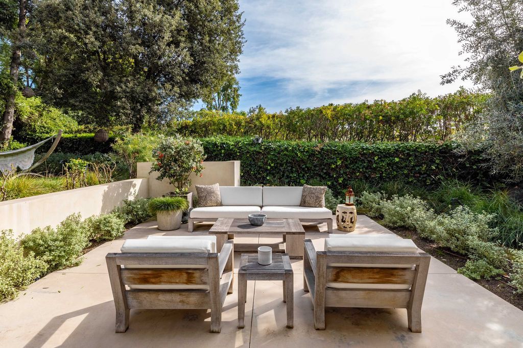 The Mid Century Home in Beverly Hills is a organic property offers total privacy, effortless indoor - outdoor living and unparalleled treetop views now available for sale. This home located at 1030 Woodland Dr, Beverly Hills, California; offering 4 bedrooms and 4 bathrooms with over 4,400 square feet of living spaces.