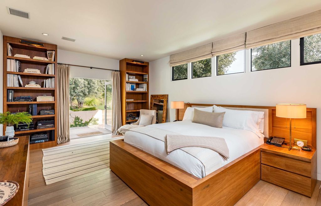 The Mid Century Home in Beverly Hills is a organic property offers total privacy, effortless indoor - outdoor living and unparalleled treetop views now available for sale. This home located at 1030 Woodland Dr, Beverly Hills, California; offering 4 bedrooms and 4 bathrooms with over 4,400 square feet of living spaces.