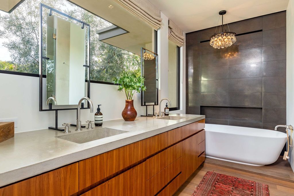 The Mid Century Home in Beverly Hills is a organic property offers total privacy, effortless indoor - outdoor living and unparalleled treetop views now available for sale. This home located at 1030 Woodland Dr, Beverly Hills, California; offering 4 bedrooms and 4 bathrooms with over 4,400 square feet of living spaces.
