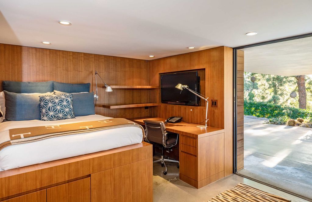 The Mid Century Home in Beverly Hills is a organic property offers total privacy, effortless indoor - outdoor living and unparalleled treetop views now available for sale. This home located at 1030 Woodland Dr, Beverly Hills, California; offering 4 bedrooms and 4 bathrooms with over 4,400 square feet of living spaces.