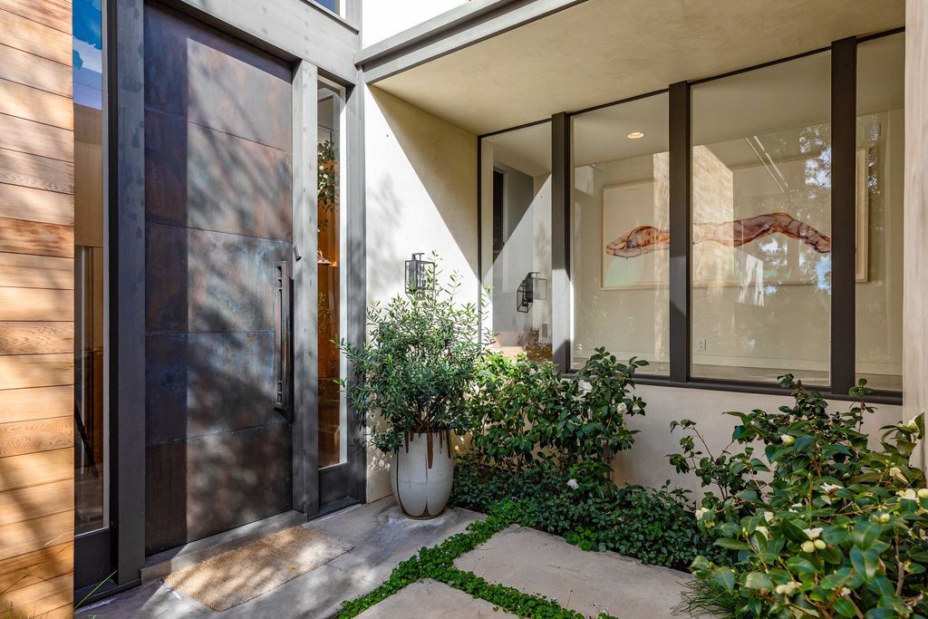 The Mid Century Home in Beverly Hills is a organic property offers total privacy, effortless indoor - outdoor living and unparalleled treetop views now available for sale. This home located at 1030 Woodland Dr, Beverly Hills, California; offering 4 bedrooms and 4 bathrooms with over 4,400 square feet of living spaces.