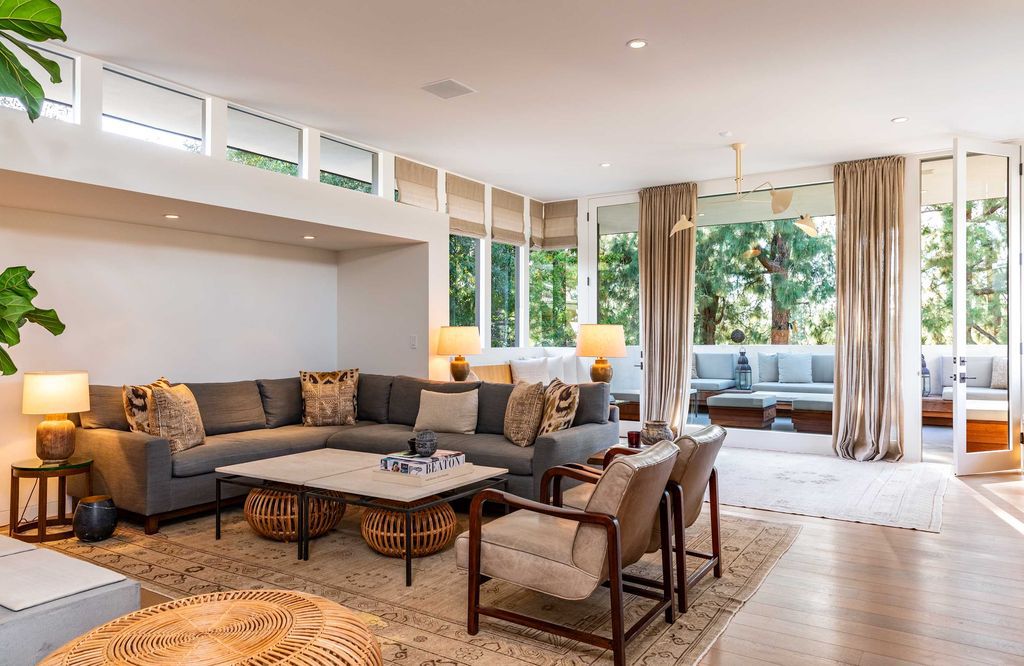 The Mid Century Home in Beverly Hills is a organic property offers total privacy, effortless indoor - outdoor living and unparalleled treetop views now available for sale. This home located at 1030 Woodland Dr, Beverly Hills, California; offering 4 bedrooms and 4 bathrooms with over 4,400 square feet of living spaces.