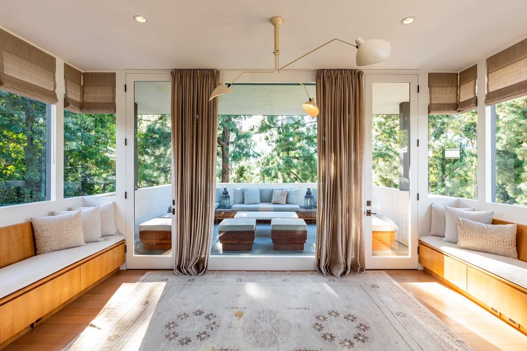 The Mid Century Home in Beverly Hills is a organic property offers total privacy, effortless indoor - outdoor living and unparalleled treetop views now available for sale. This home located at 1030 Woodland Dr, Beverly Hills, California; offering 4 bedrooms and 4 bathrooms with over 4,400 square feet of living spaces.