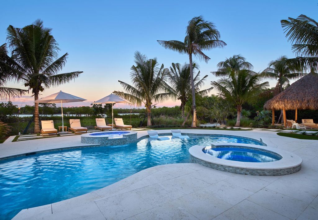 The Home on Marco Island is a Incredible island sanctuary nestled along the natural shoreline of Barfield Bay now available for sale. This home located at 899 Caxambas Dr, Marco Island, Florida; offering 5 bedrooms and 5 bathrooms with over 6,000 square feet of living spaces.
