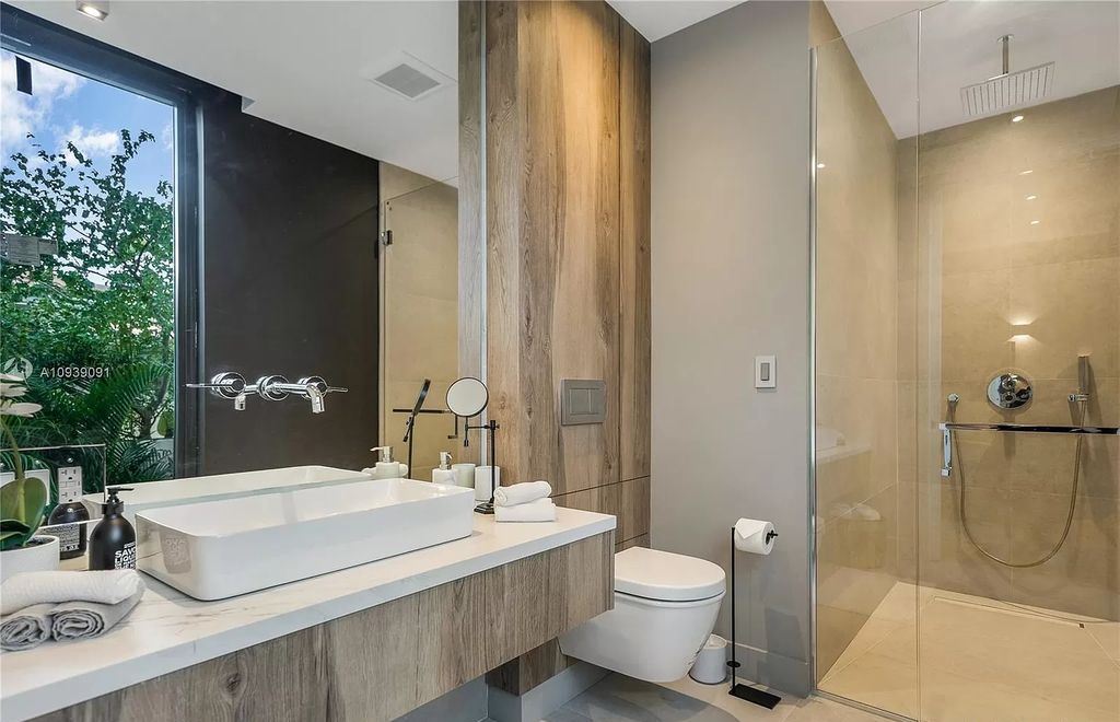 The Miami Beach Home is a new construction modern masterpiece located within the serene gated community of Normandy Isle now available for sale. This home located at 770 S Shore Dr, Miami Beach, Florida; offering 4 bedrooms and 5 bathrooms with over 5,000 square feet of living spaces.