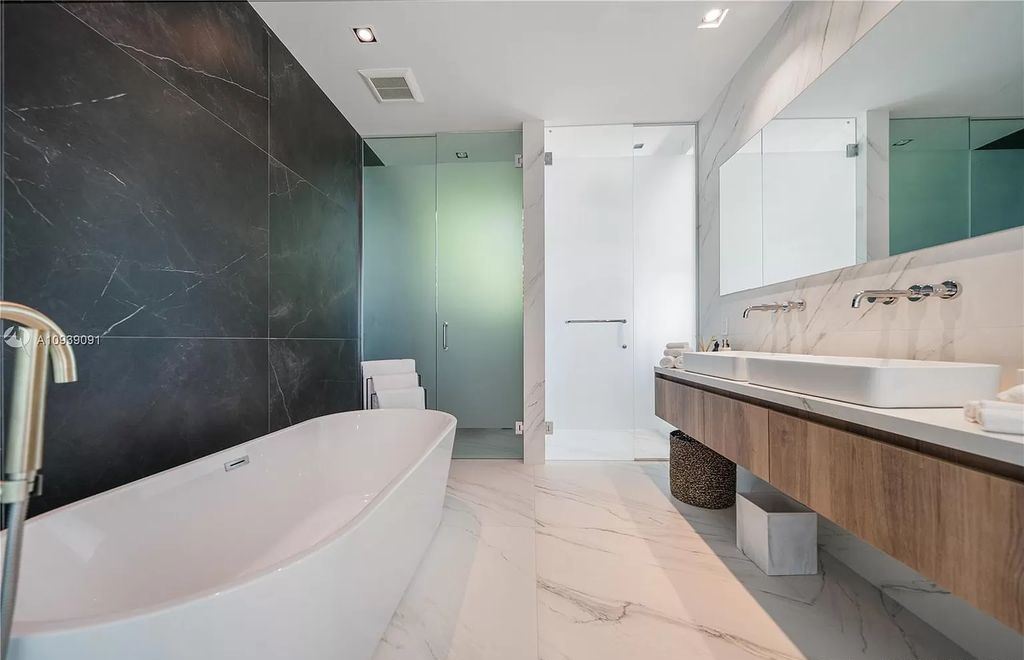 The Miami Beach Home is a new construction modern masterpiece located within the serene gated community of Normandy Isle now available for sale. This home located at 770 S Shore Dr, Miami Beach, Florida; offering 4 bedrooms and 5 bathrooms with over 5,000 square feet of living spaces.