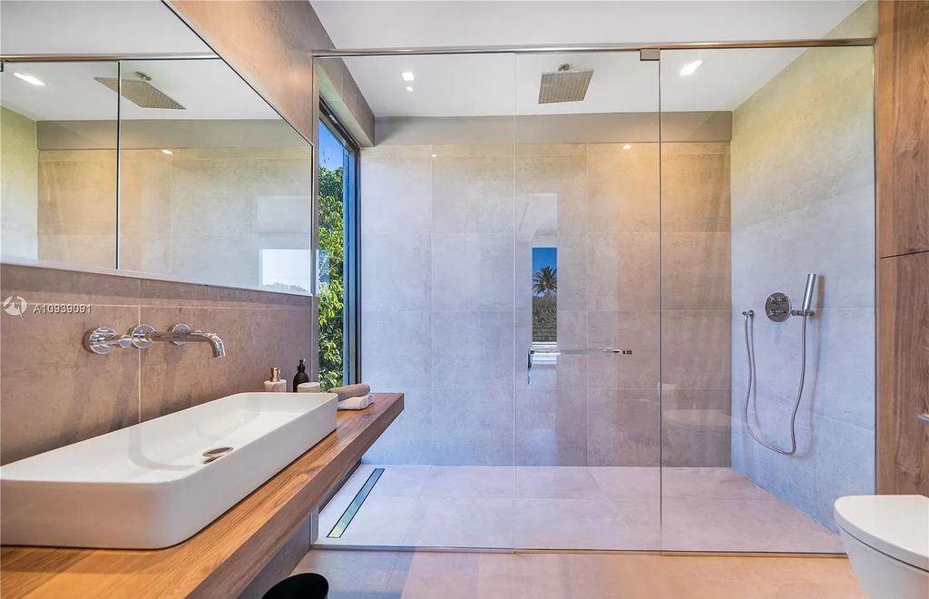 The Miami Beach Home is a new construction modern masterpiece located within the serene gated community of Normandy Isle now available for sale. This home located at 770 S Shore Dr, Miami Beach, Florida; offering 4 bedrooms and 5 bathrooms with over 5,000 square feet of living spaces.