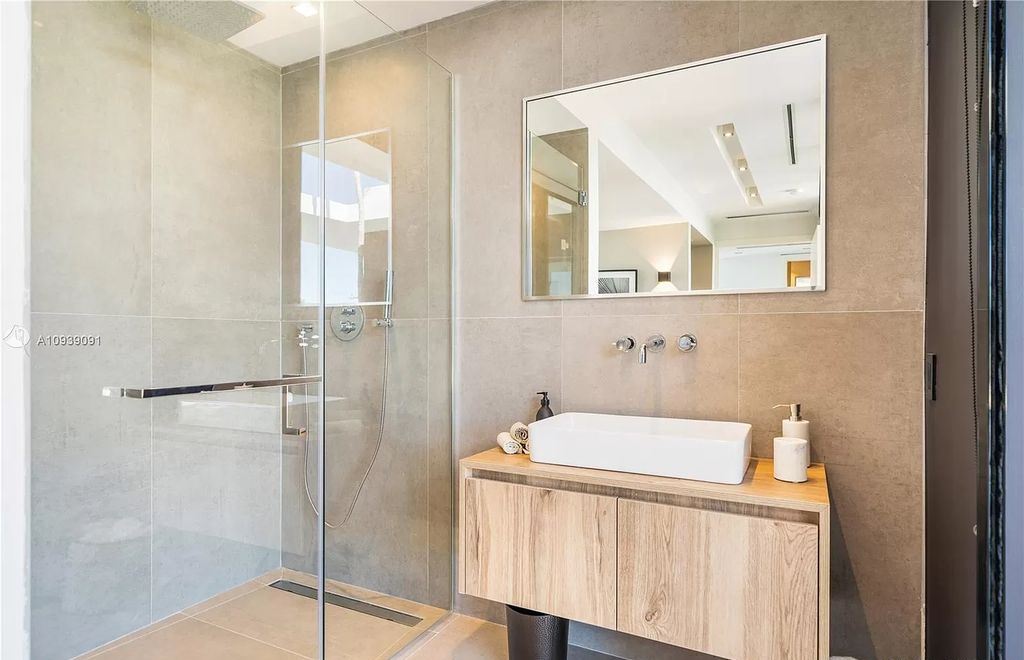 The Miami Beach Home is a new construction modern masterpiece located within the serene gated community of Normandy Isle now available for sale. This home located at 770 S Shore Dr, Miami Beach, Florida; offering 4 bedrooms and 5 bathrooms with over 5,000 square feet of living spaces.