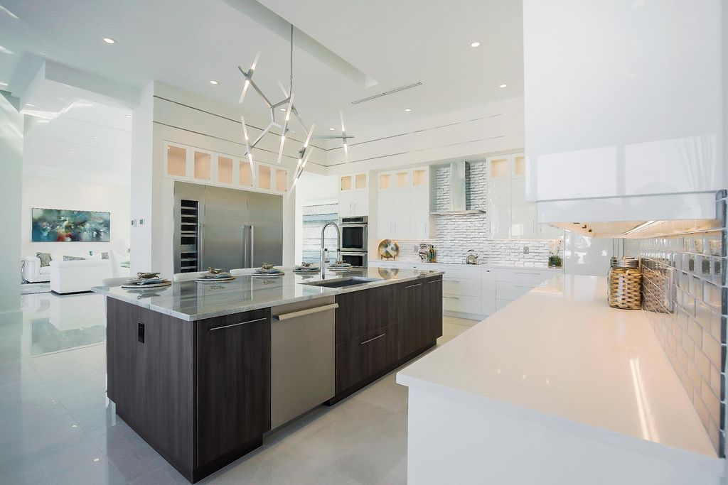 The Florida Waterfront Home is an exceptional estate with immaculate contemporary finishes designed by Zahn Builders now available for sale. This home located at 2431 NE 32nd Ct, Lighthouse Point, Florida; offering 5 bedrooms and 6 bathrooms with over 5,600 square feet of living spaces.